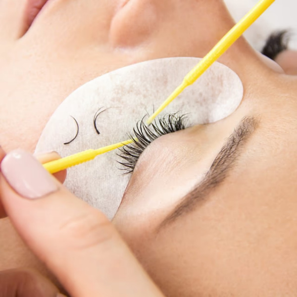 Lash artist is removing lash extensions from client's eye